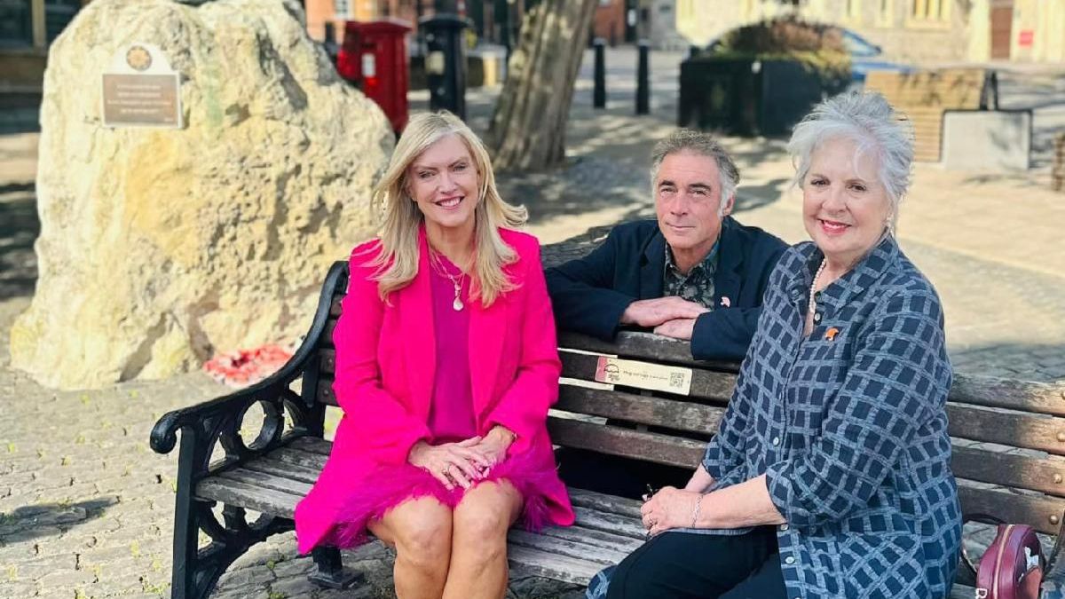 Good Grief Trust Founder Linda Magistris sits with Patron Dame Penelope Wilton and Ambassador Greg Wise at the statue of the Irish Guard in Windsor.